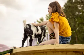 Emma snuggling Piper the goat
